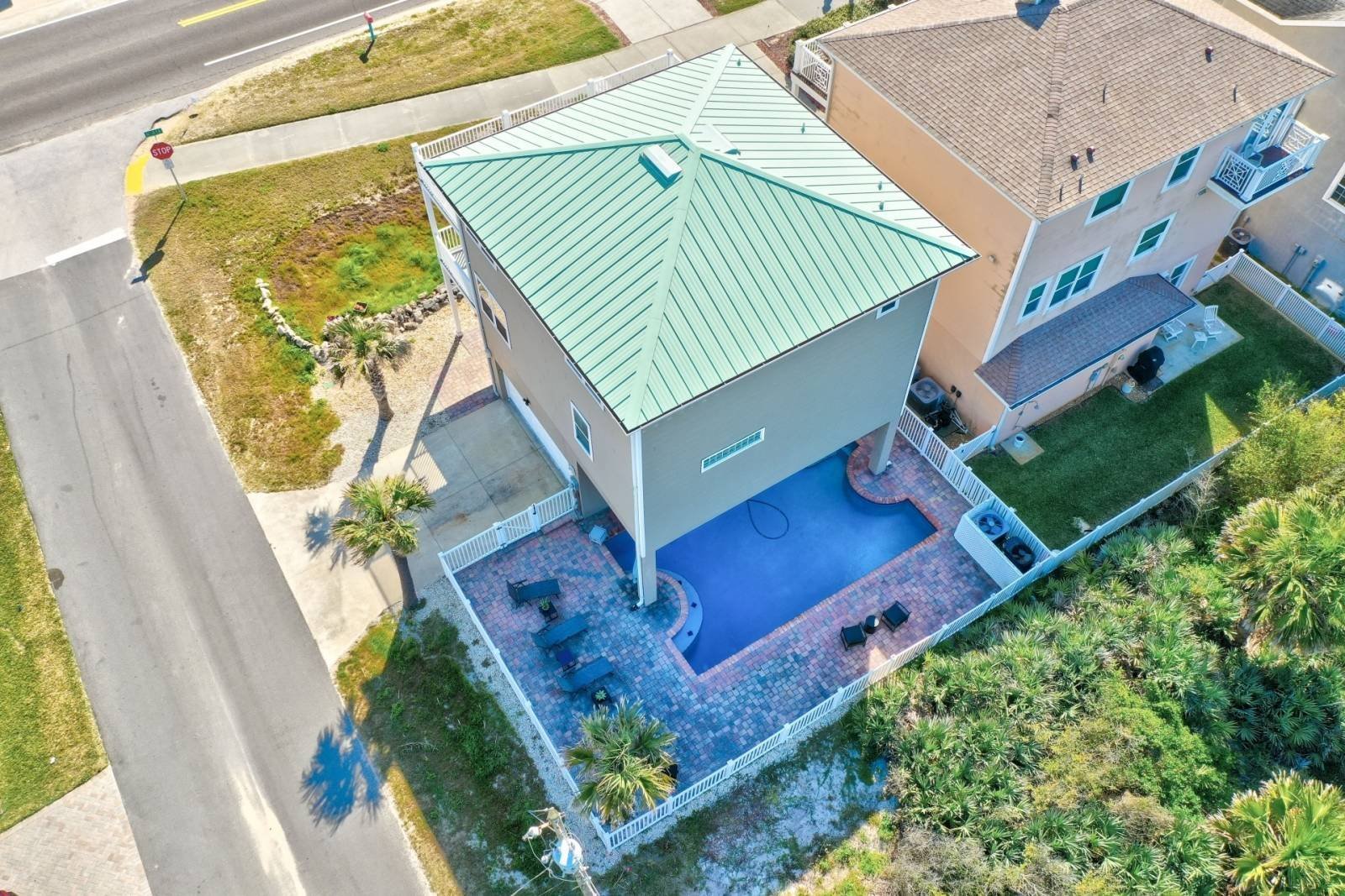 Top-down aerial of the property showing roof, pool, and lot