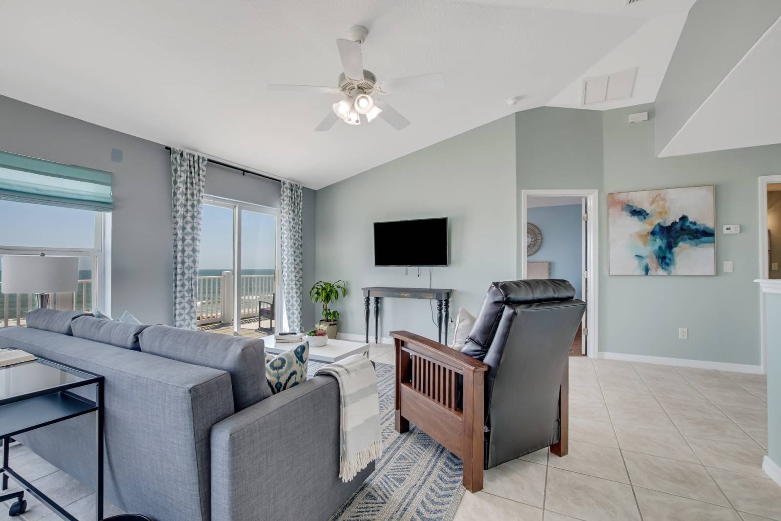 Upper living area with vaulted ceilings and gray sofa
