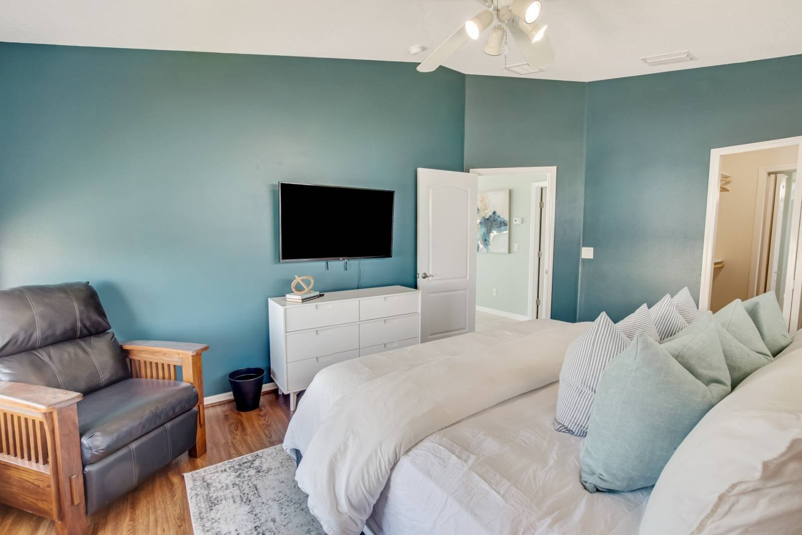 Bedroom with leather seating and TV